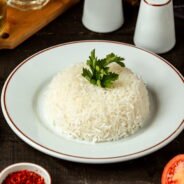 side-view-plate-with-cooked-rice-with-parsley-table (1)